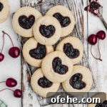 TikTok-Inspired Jam Heart Cookies Recipe 6 A wire rack over a piece of white wood with a pile of tiktok jam heart cookies.