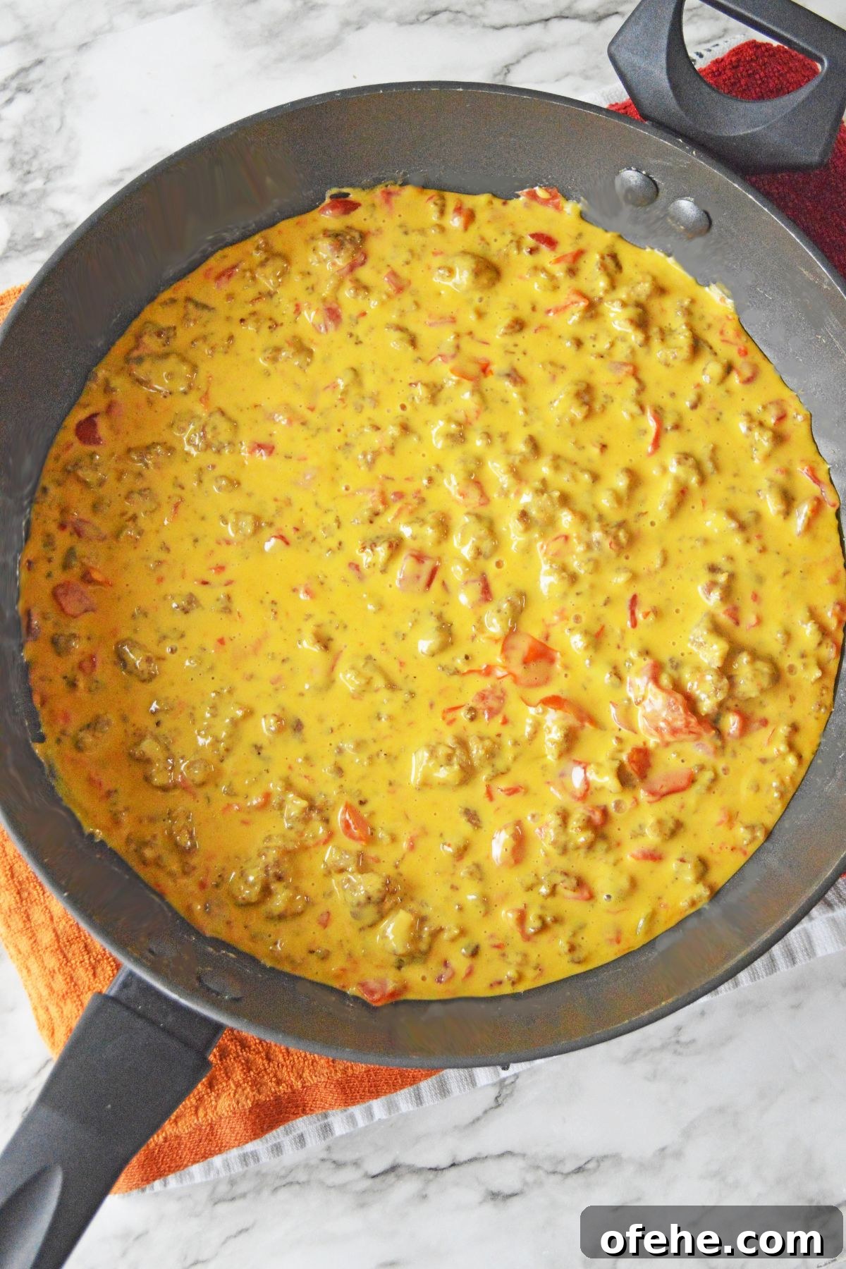 Creamy Queso Dip with Rotel Tomatoes and Diced Chilies 6 melted cheese, tomatoes, and sausage in a large skillet.