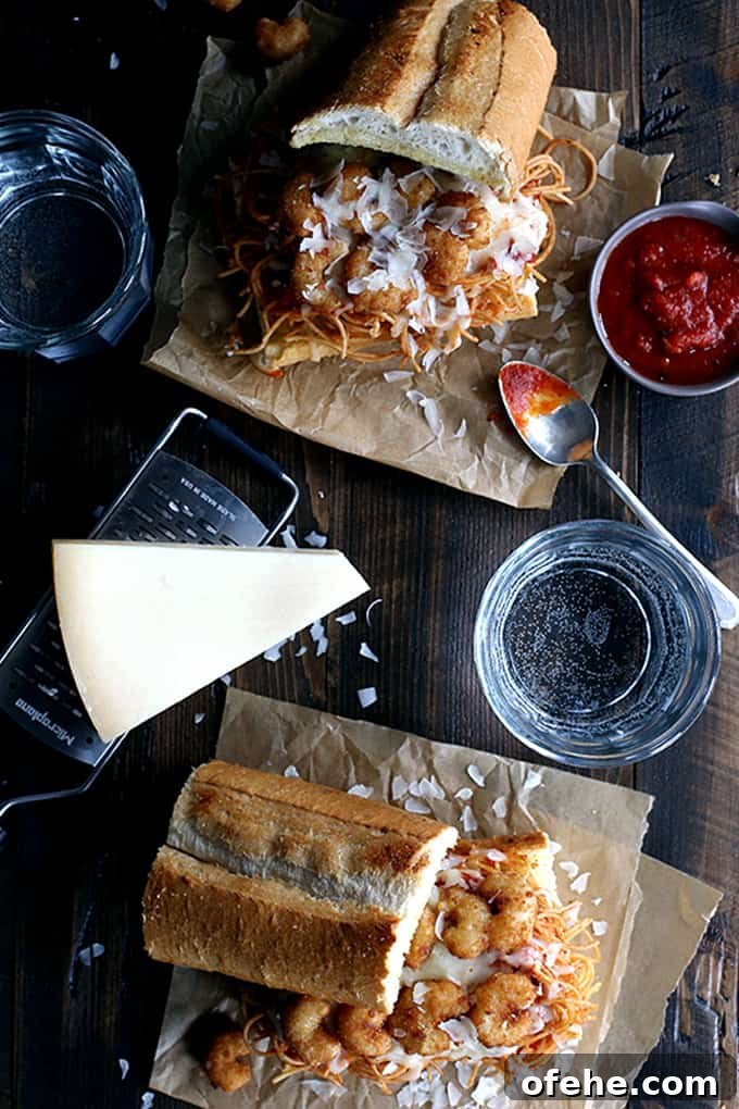 Sandwich assembly Layered sandwich components: spaghetti, marinara, shrimp and cheese