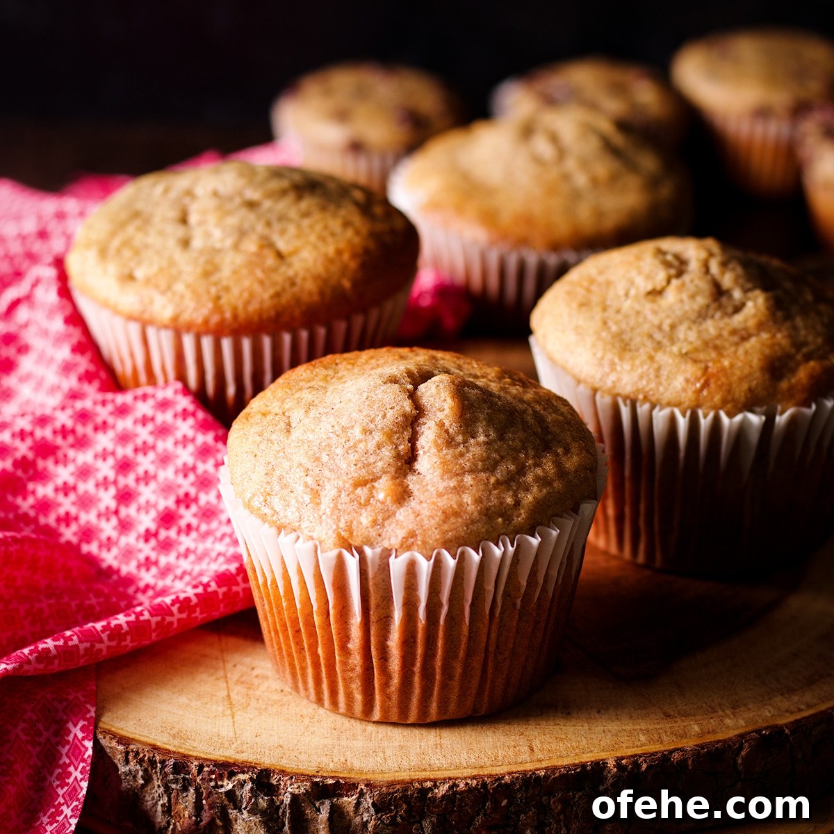 Jumbo size gluten free banana muffins on a wood serving platter.