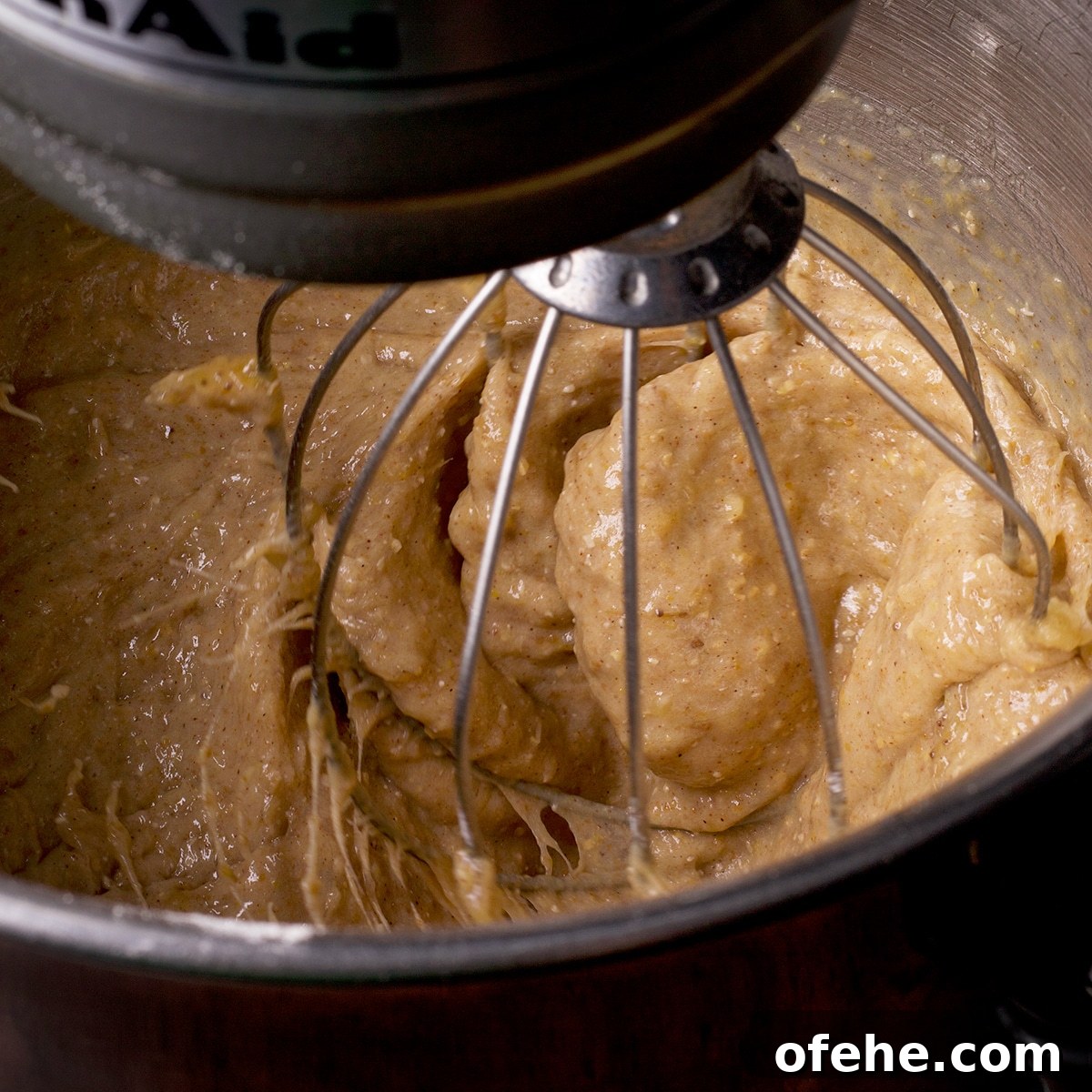 Mixing dry ingredients into wet ingredients to make gluten free banana muffin batter.