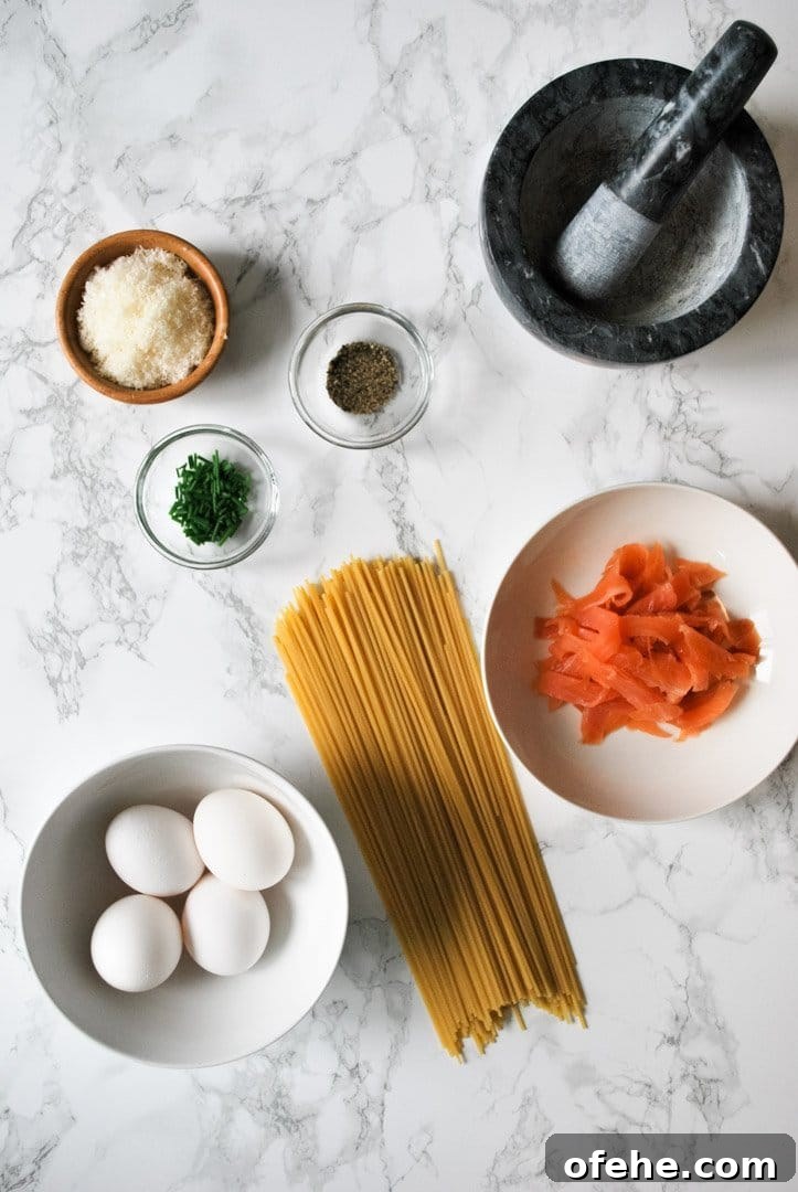 Ingredients for smoked salmon carbonara spread out on the kitchen counter ready to be prepared.