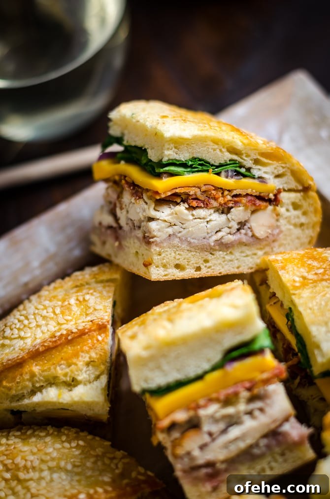 Pressed Chicken & Bacon Picnic Sandwiches with Raspberry Honey Mustard 3 Chicken Bacon Pressed Picnic Sandwiches with Raspberry Honey Mustard. These tangy smash-hit sandwiches are great for potlucks, barbecues, picnics, parties, and all that lies in-between. With a raspberry honey mustard, chicken, bacon, cheddar cheese, red onion, and baby spinach filling, they are always devoured. Plus, you can easily make them ahead of time and transport them with no stress! | hostthetoast.com