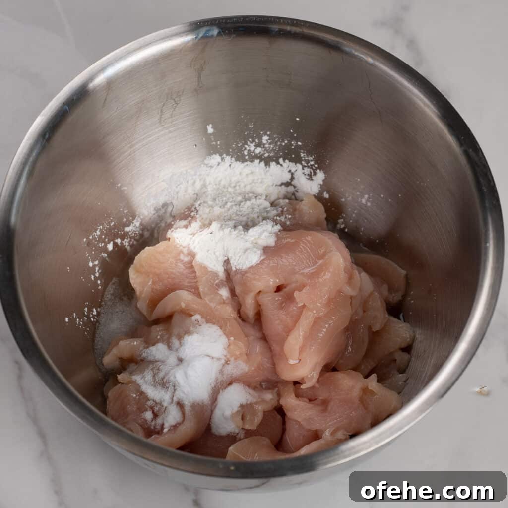 Garlic Chicken with Broccoli Stir-Fry Recipe 4 Chicken being marinated in silver large bowl