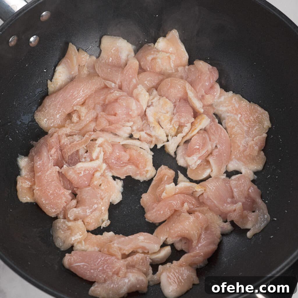 Garlic Chicken with Broccoli Stir-Fry Recipe 5 Chicken being seared in wok