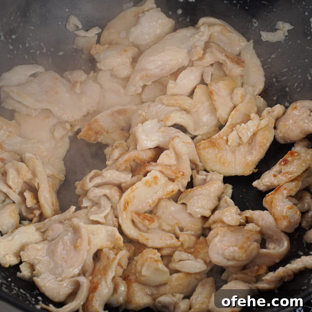Garlic Chicken with Broccoli Stir-Fry Recipe 6 Chicken being seared into wok