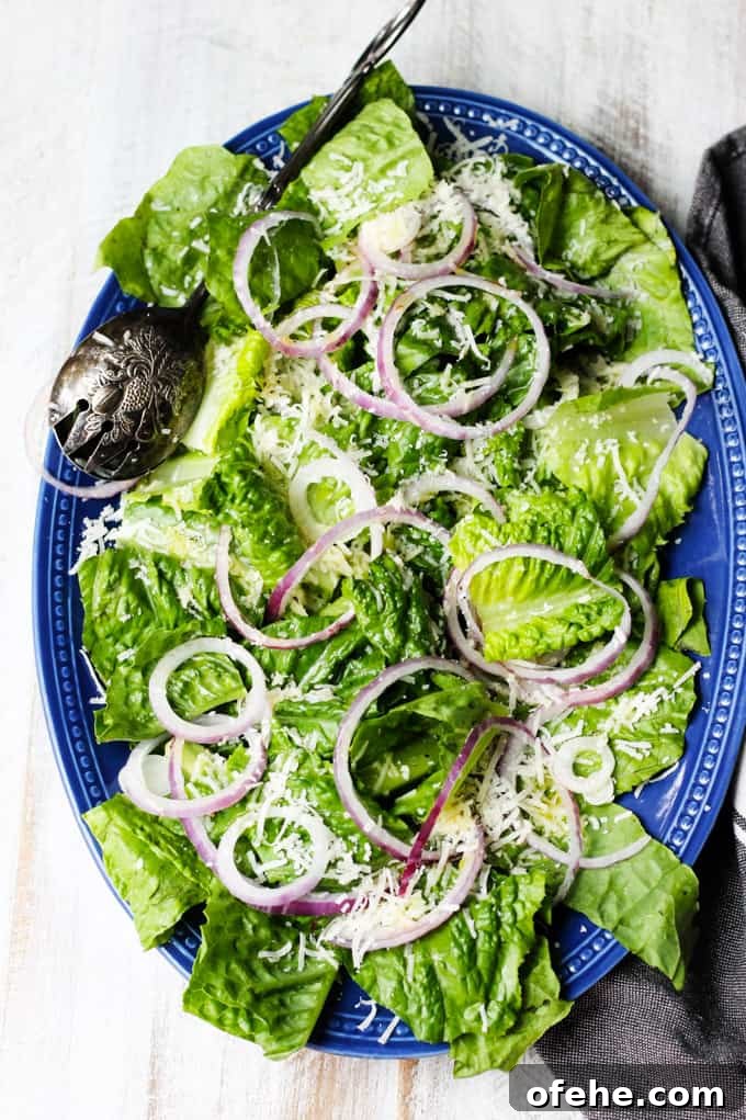 Crisp Spring Green Salad with Lemon-Herb Vinaigrette 6 Simple green salad on a blue plate with towel on a side