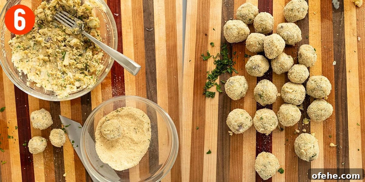Italian Eggplant Meatballs in Tomato Sauce 9 Breading eggplant meatballs on a cutting board.