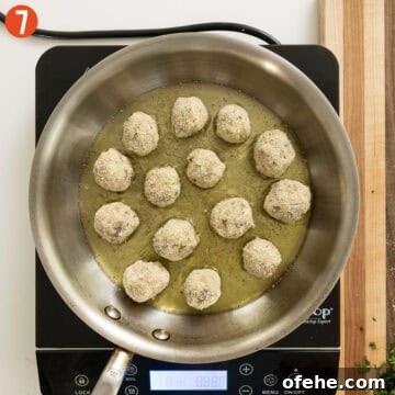 Italian Eggplant Meatballs in Tomato Sauce 10 Frying eggplant meatballs in a sauce pan.