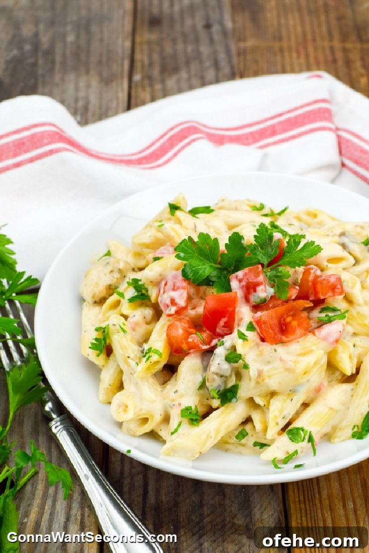 Chicken alfredo topped with chopped tomatoes