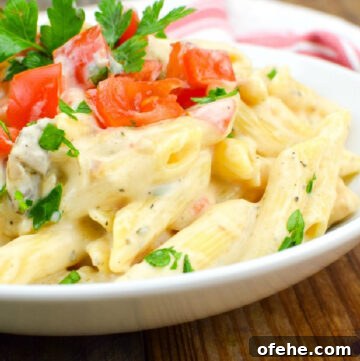 Chicken alfredo topped with chopped tomatoes