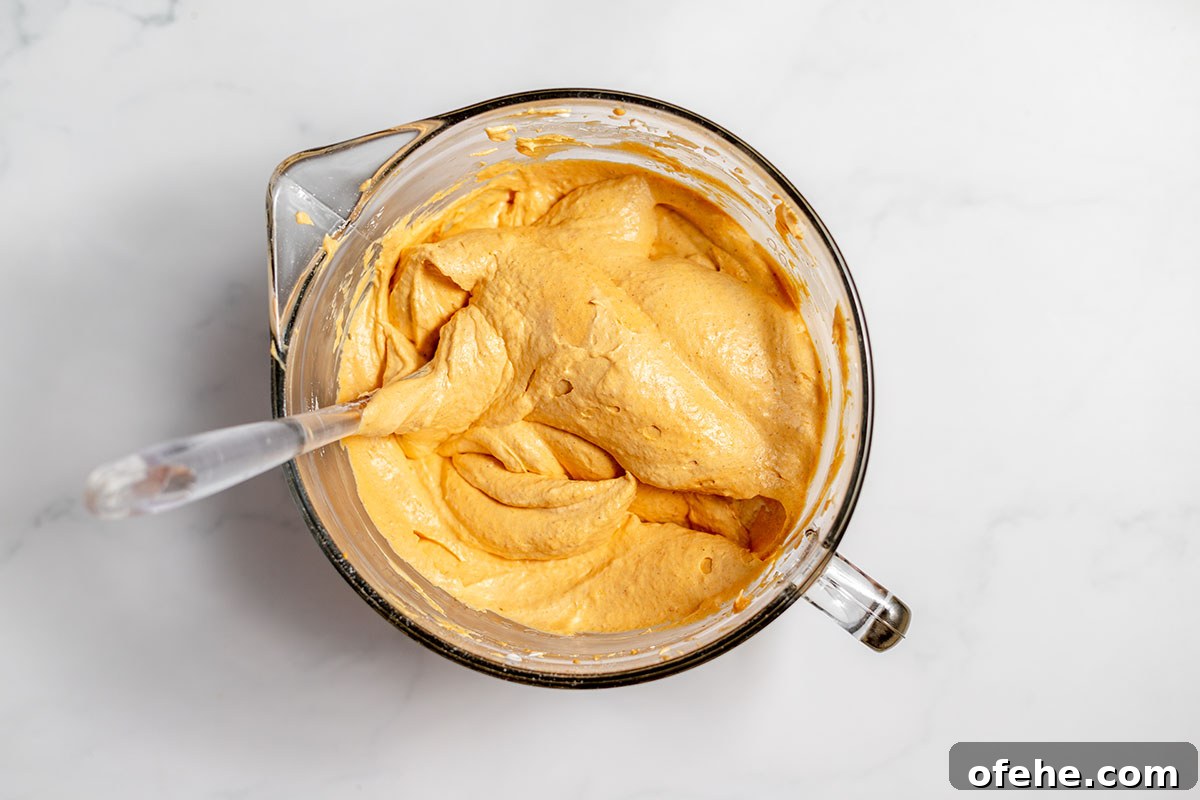 Pumpkin cheesecake batter in mixing bowl.
