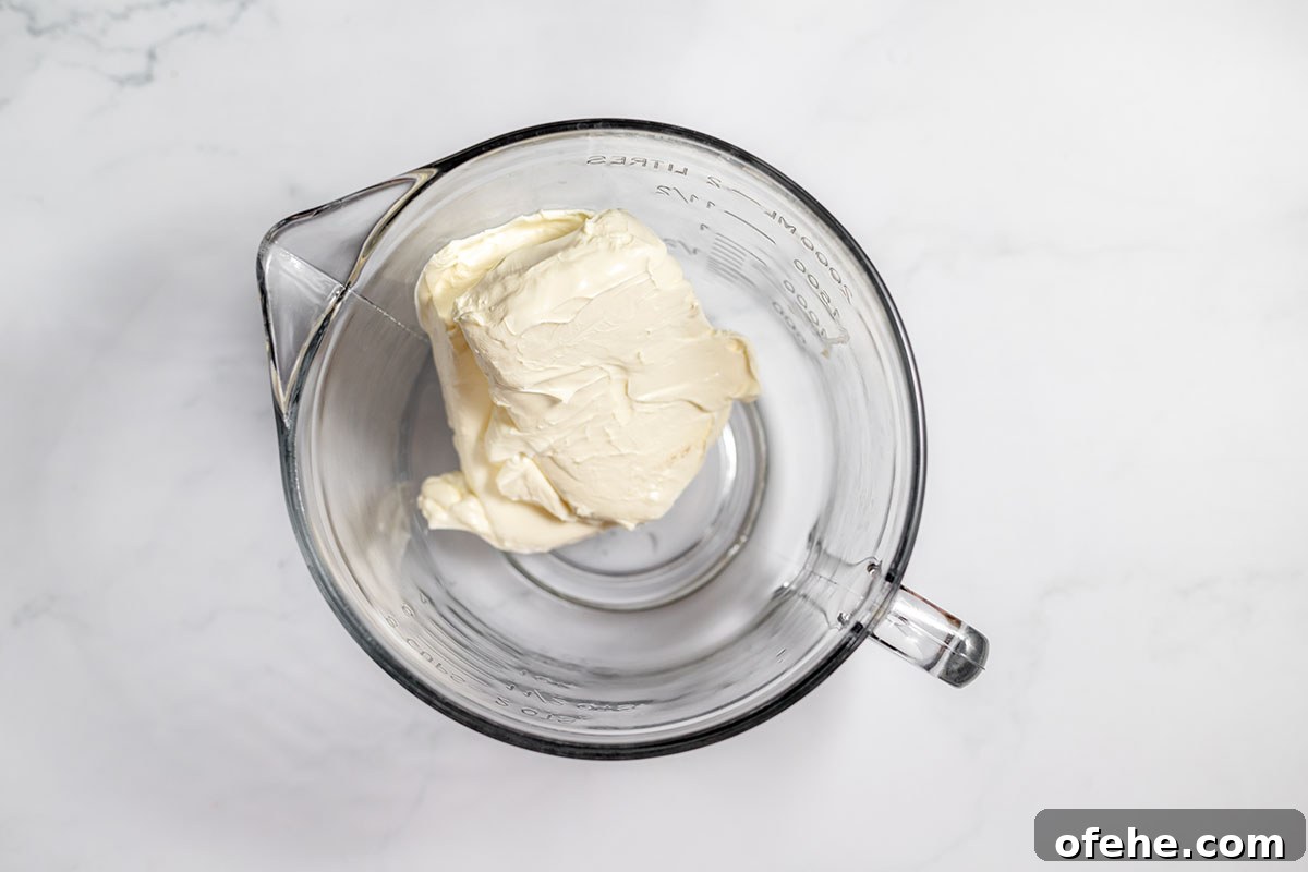 Softened cream cheese in mixing a bowl.
