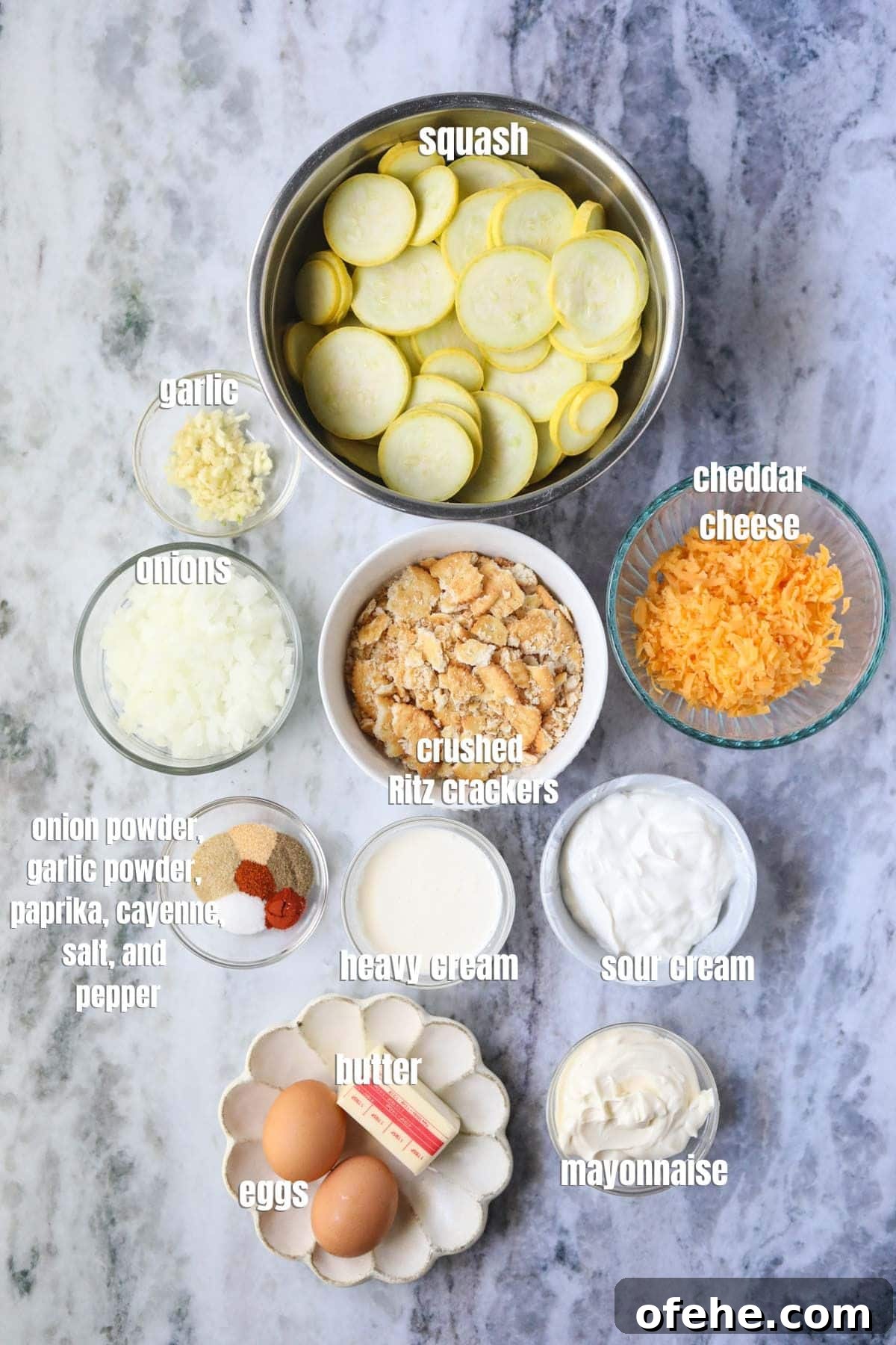 Southern Squash Casserole with Cheesy Cornbread Topping 3 Ingredients for making southern squash casserole arranged on a marble countertop.