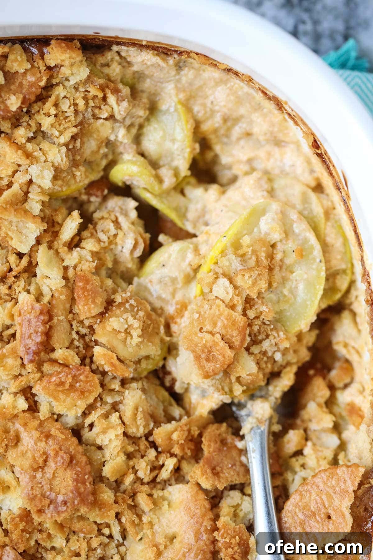 Southern Squash Casserole with Cheesy Cornbread Topping 9 Southern squash casserole in a white baking dish.
