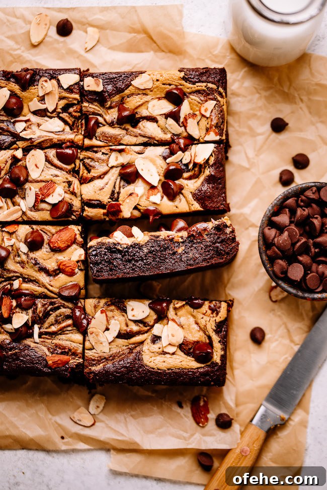 Fudgy Almond Butter Tahini Brownies 4 Almond butter swirled brownies on parchment paper
