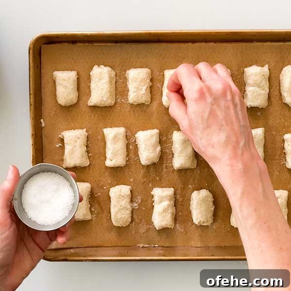 Sprinkling for sea salt over the top of the pretzel bites.
