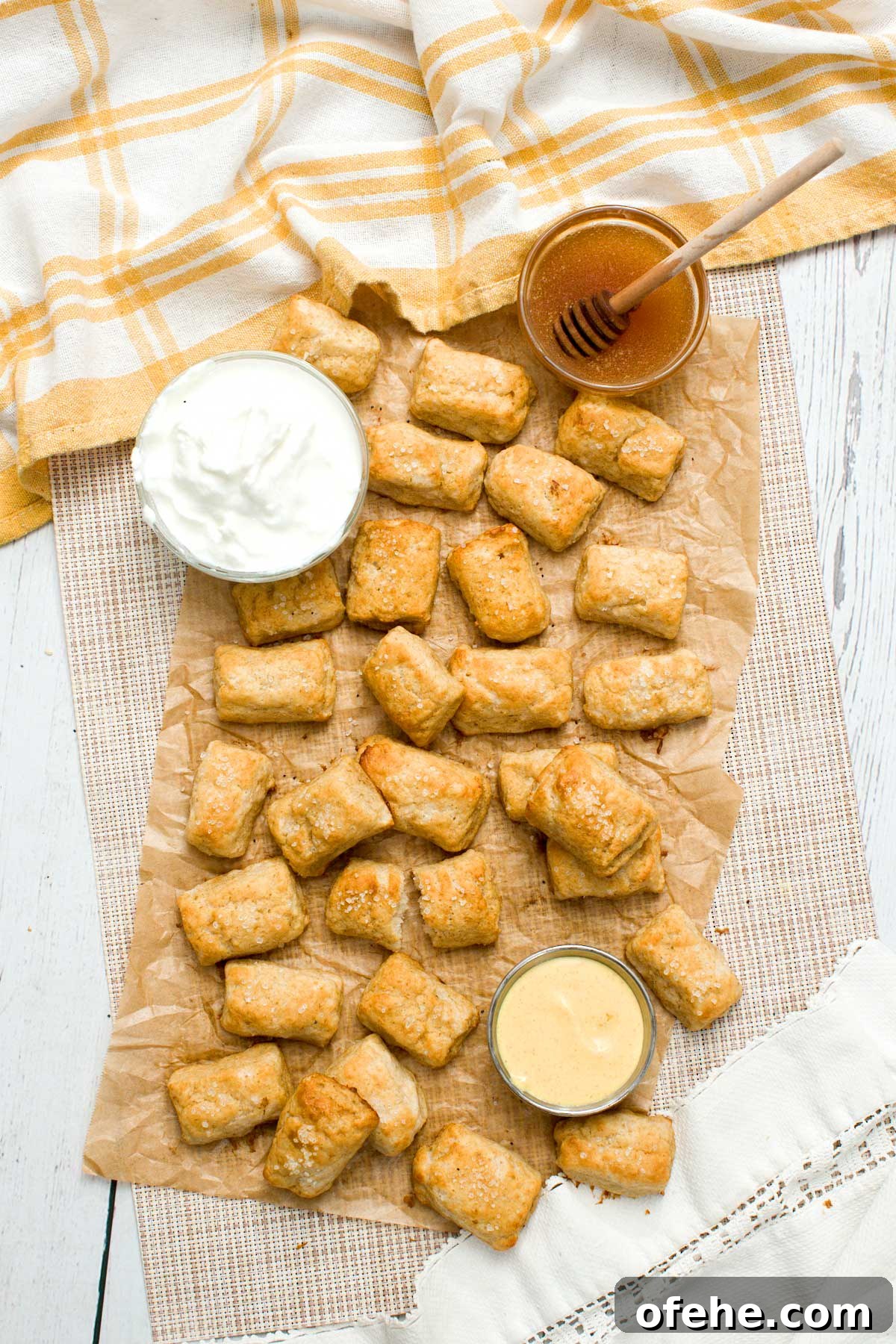 Gluten-free pretzel bites on hard paper with Greek yogurt.