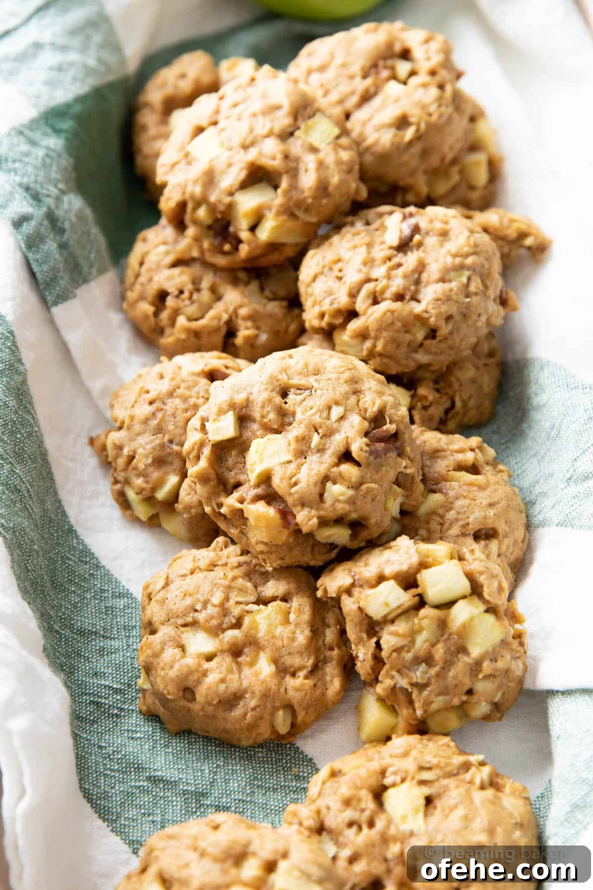 Vegan Apple Pie Breakfast Cookies for Cozy Mornings 4 a dozen apple pie breakfast cookies laying on a green striped napkin