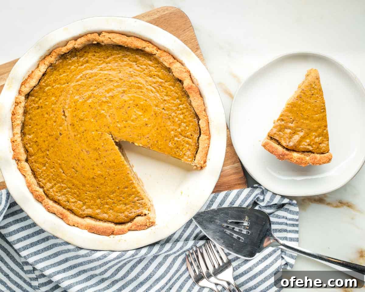 Wholesome Thanksgiving Recipes 2025 for a Lighter Feast 24 Pumpkin pie with one slice already on a plate.