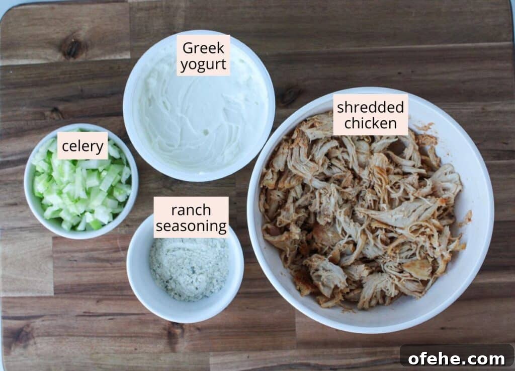 Shredded chicken, plain Greek yogurt, ranch seasoning and diced celery in small bowls with labels.