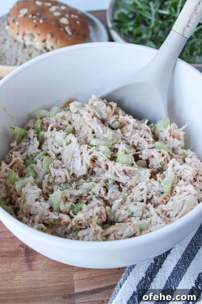 A close up shot of 4-ingredient chicken salad in a cream bowl.