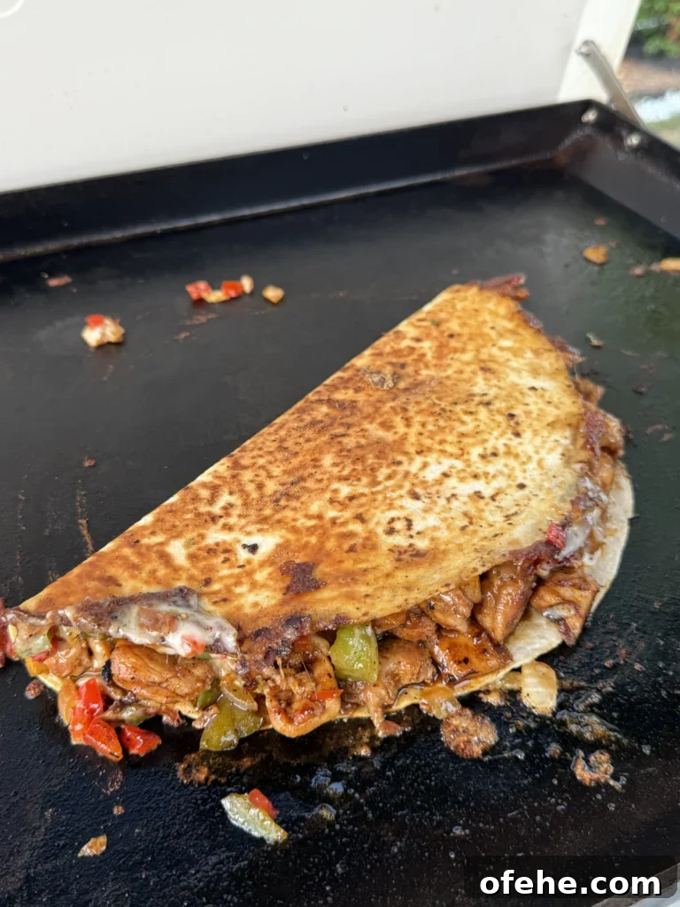 Cheesy Chicken Bacon Ranch Quesadillas 8 flipped quesadilla on the griddle