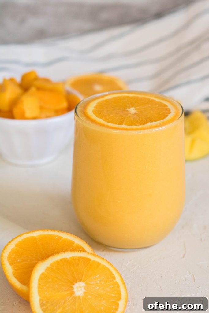 Low-Calorie Apple Cider Vinegar Drink Recipe You Will Love 8 Mango orange smoothie with an orange slice on top