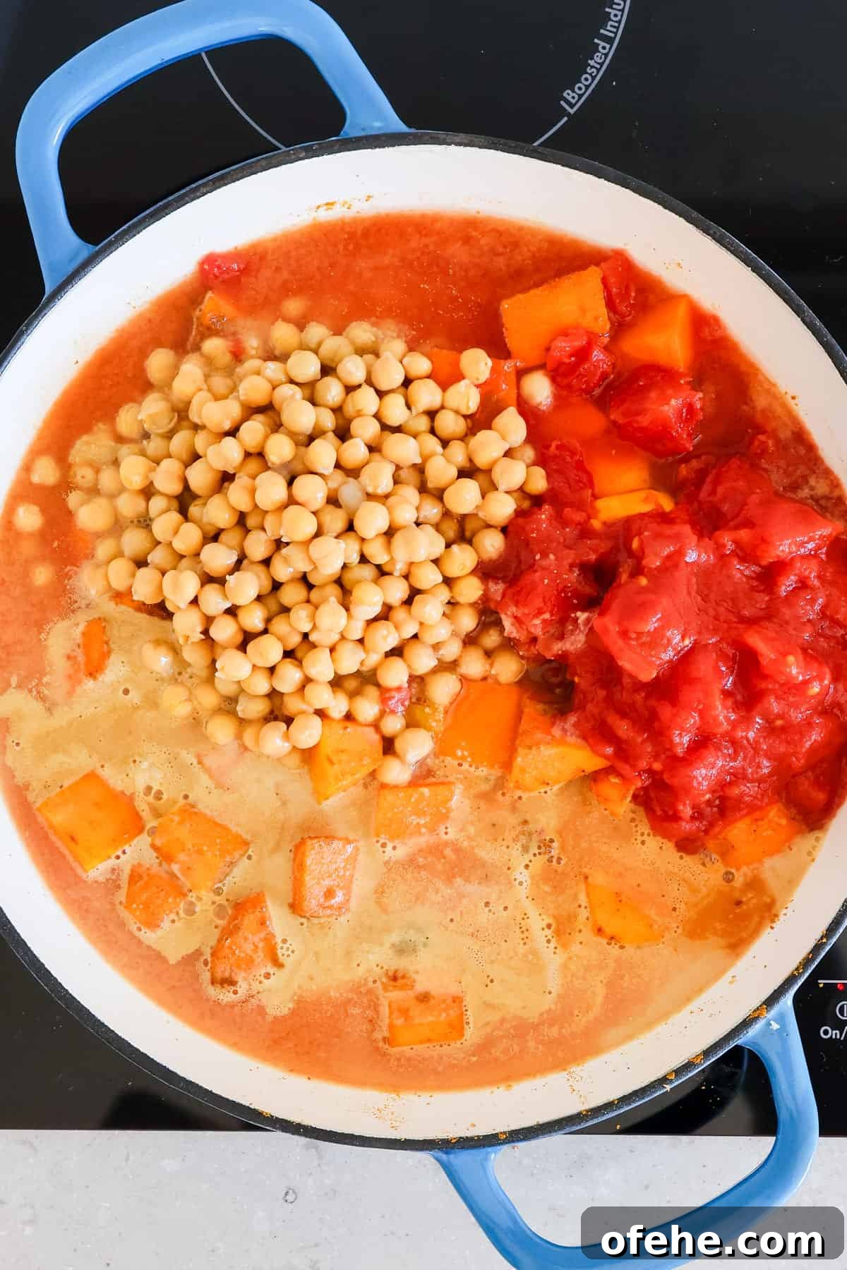 Tomatoes, chickpeas and peanut butter added to the pot.